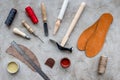 Clobber preparing his tools for work. Grey stone desk background top view