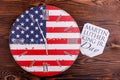 Clock in the American Flag coloring close-up on a wooden background with a note