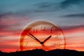 Clock on the background of the sunset sky and the silhouette of the mountains. Double exposure. The concept of time Royalty Free Stock Photo