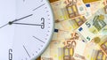 Clock and banknotes of Euro. Concept time is money. View from above. Business, finance. Royalty Free Stock Photo