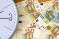 Clock and banknotes of Euro. Concept time is money. View from above. Business, finance. Royalty Free Stock Photo