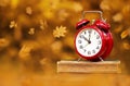 Clock on books with leaves, back to school in autumn background