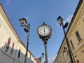 Clock and buildings on a street in Baia Mare city, Romania Royalty Free Stock Photo