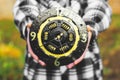 A clock from a car clutch disc. Black watch with gold elements. Man holding a clock in his hands Royalty Free Stock Photo