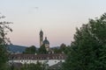 Clock church tower seen through tree at sunset blue hour Royalty Free Stock Photo
