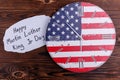 Clock in the coloring of the American flag on a wooden background