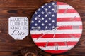 Clock in the American flag coloring on a wooden background close-up