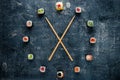 Watch sushi with chopsticks by the arrows, the concept of time to eat Royalty Free Stock Photo