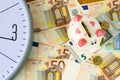 Clock, Euro banknotes and piggy bank. Concept time is money. View from above. Business, finance. Royalty Free Stock Photo