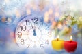 Clock face and Christmas candles lights in the frosty background Royalty Free Stock Photo