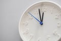 Clock face showing twelve o`clock with white background. White round wall clock. Twelve o`clock. Midday or midnight. 12 a.m. or Royalty Free Stock Photo