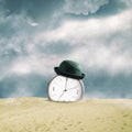 Clock with a hat in the sand dunes. Cloudy sky. Time concept. Business. Lifestyle. Square orientation Royalty Free Stock Photo