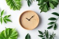 Clock on light background among green leaves. Wall clock, morning time. Minimalistic background, concept of time, time to work, Royalty Free Stock Photo