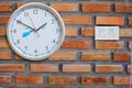 Clock and Light switch on the brick Royalty Free Stock Photo