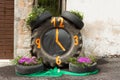 Clock made with car tires and flowers on \