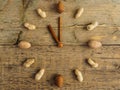 Clock made of different nuts and cinnamon on wooden background. The clock strikes eleven o`clock. Hours of proper nutrition Royalty Free Stock Photo