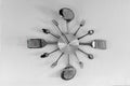 Clock made of spoons and forks on the wall