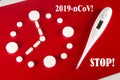 Clock made of white tablets and thermometer with inscription 2019- nCoV , STOP on red background, top view. 2019 Novel Coronavirus