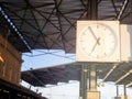 Clock at the railway station close-up in sunlight. Travel, work, timetable concept.