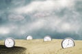 Clock in the sand dunes. Show different times. Cloudy sky. Time concept. Business. Life style Royalty Free Stock Photo