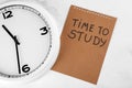 Clock and sheet of paper with inscription TIME TO STUDY on light background. Time management concept Royalty Free Stock Photo