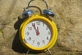 A clock shows five minutes to twelve. Royalty Free Stock Photo