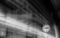 The clock shows the time on the skytrain station with iron structure roof background. Toned Monochrome Royalty Free Stock Photo