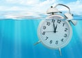 Clock sink in water, time limited concept Royalty Free Stock Photo