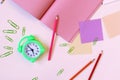 Clock, stationery, blank notepads on the table, top view Royalty Free Stock Photo