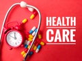 Clock,stethoscope and pill with text HEALTH CARE Royalty Free Stock Photo