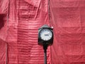 Clock on the street before a scaffolded wall