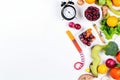 A clock surrounded by fruits and vegetables on a white background. Generative ai Royalty Free Stock Photo