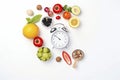 A clock surrounded by fruits and vegetables on a white background. Generative ai Royalty Free Stock Photo