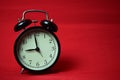 Clock ticking to 9 o`clock on the red background