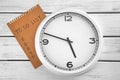 Clock with to-do list on wooden background. Time management concept