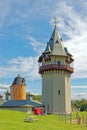 clock tower with clocks on each face side and weathervane on top