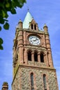 The clock tower in Derry Guildhall in a sunny day