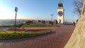 The clock tower on the fortress and the tree without leaves in autumn day in Serbia, city of Petrovaradin - Novi Sad. Royalty Free Stock Photo