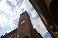 Clock tower framed by a building with a cloudy sky as background Royalty Free Stock Photo