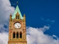 The clock tower of the Guildhall in Derry ~ Londonderry. Taken on a sunny day with blue sky and white clouds