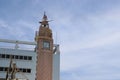 Clock tower at Mahachai port isolated on blue sky and white cloud closeup.