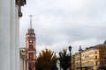 Clock tower, old buildings with Windows, columns, tree crowns in autumn, St. Petersburg