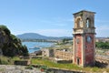 The Clock Tower of The Old Fortress of Corfu with Garitsa Bay and an yacht marina at the background, Kerkyra, Corfu Island, Greece Royalty Free Stock Photo