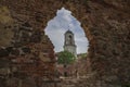 The clock tower in the opening of the wall of the destroyed cathedral. Vyborg