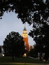 Clock tower Pulliam Hall on campus in Carbondale Illinois at dusk, framed by trees and warm lights Royalty Free Stock Photo