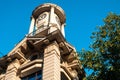 a clock tower in the middle of a building with a sky background Royalty Free Stock Photo