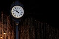 Clock tower on street park night with bokeh lighting gold yellow background romantic nightlife Royalty Free Stock Photo