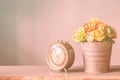 Clock and a vase of flowers. Royalty Free Stock Photo