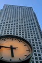 Clock with very tall steel office building