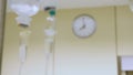 Clock on wall and medicine dropperr in surgery room.